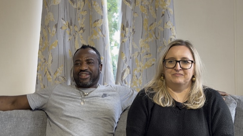 A couple sitting together in a caravan lounge